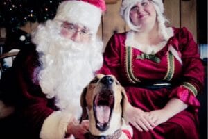 Mr and Mrs Claus with yawning dog